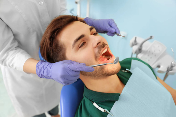 Professional dentist working with patient in modern clinic - Fotografie, Obrázek