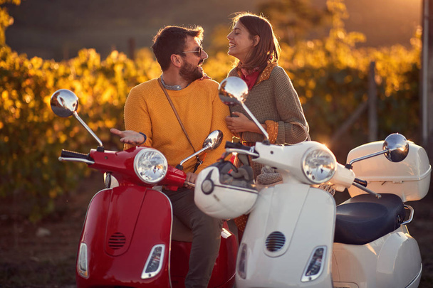 couple on scooter enjoying in romantic road trip - Foto, afbeelding