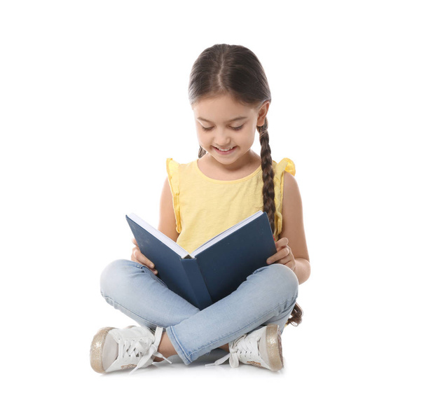 Cute little child reading book on white background - Foto, afbeelding