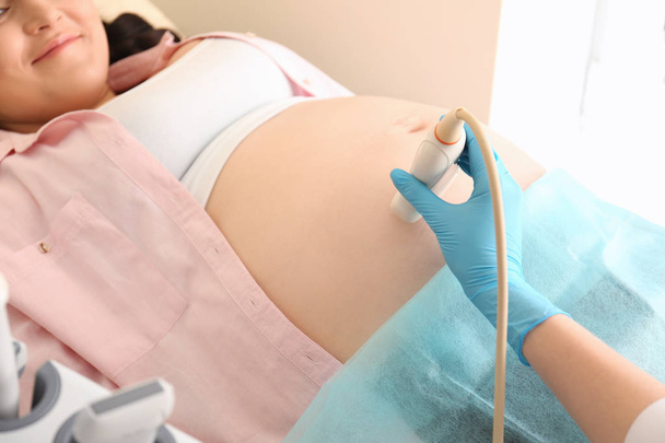 Pregnant woman undergoing ultrasound scan in clinic, closeup - Foto, Imagem