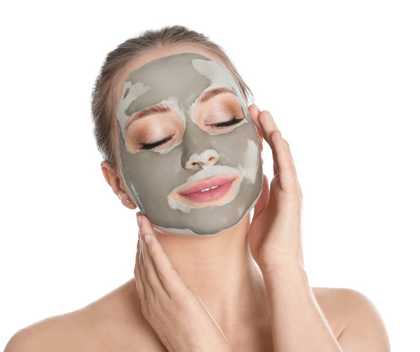 Beautiful woman with clay mask on her face against white background - Foto, Bild