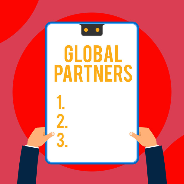 Text sign showing Global Partners. Conceptual photo Two or more firms from different countries work as a team Two executive male hands holding electronic device geometrical background. - Photo, Image