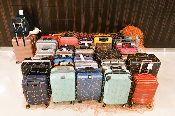 Luggage bags at hotel concierge isolated and secured with netting - Photo, Image