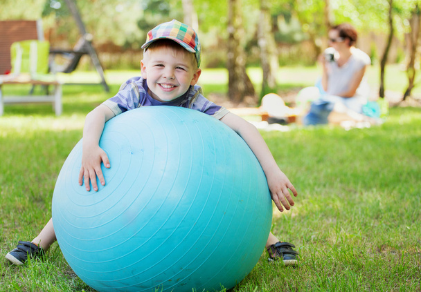 Little gentleman playing a big ball - Фото, изображение
