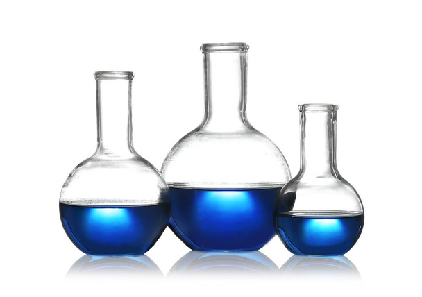 Florence flasks with liquid samples on white background. Chemistry glassware - Photo, Image