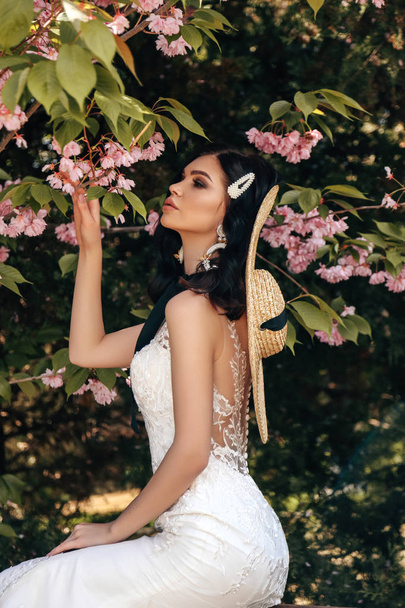 beautiful woman with dark hair in luxurious wedding dresses with - Fotoğraf, Görsel