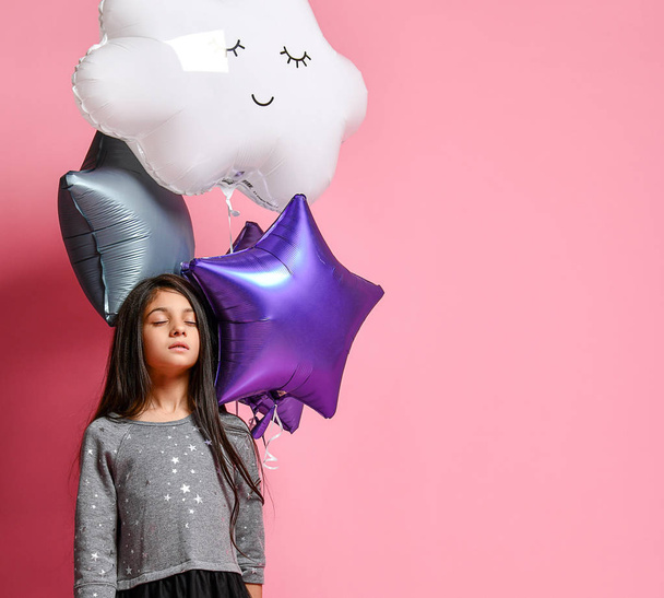 beautiful surprised girl with red hair holding pink air balloons and looking at camera on grey - Foto, immagini