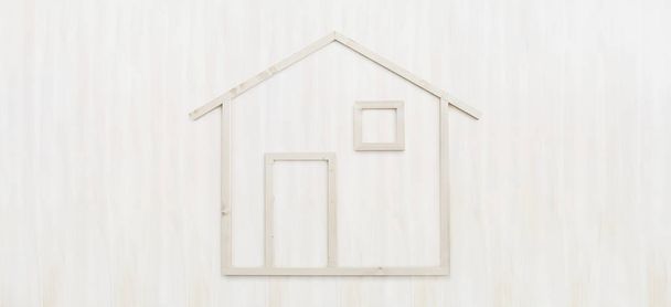 wood house shape isolated on wooden white background - 写真・画像