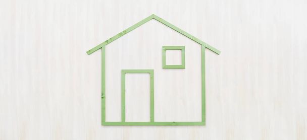 wood green house shape isolated on wooden white background, gree - 写真・画像