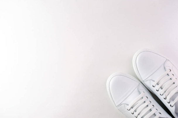A pair of white leather sneakers on a white background. View from above. - Photo, image