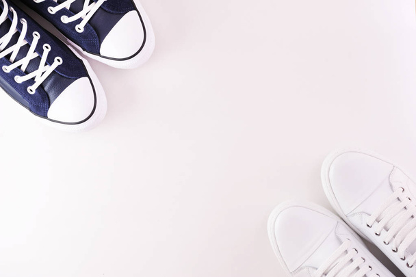 Two pairs of leather sneakers on a white background. View from above. - 写真・画像