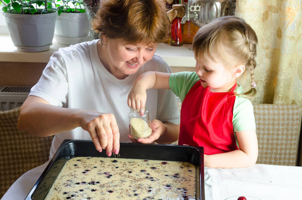 Portret van gezichten, handen gelukkig oma, kleindochter. peuter meisje spelen met bakken, deeg, meel op keuken. kind baby proberen te studeren koken koekjes, cake. Gezellige familie kijken naar elkaar - Foto, afbeelding