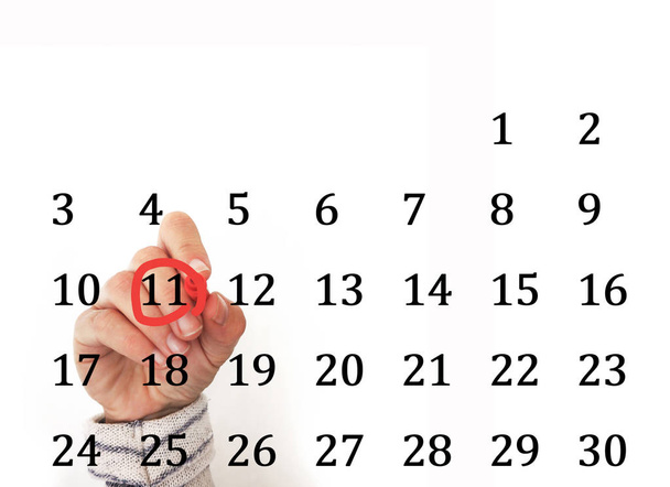hand encircling date in calendar - Photo, Image