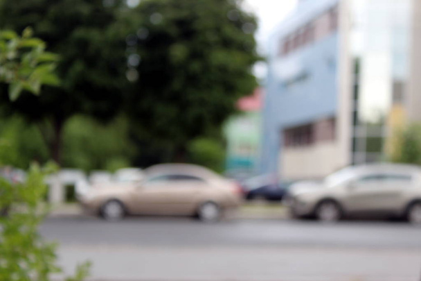 blurred background cars stand on city street in summer - Фото, зображення