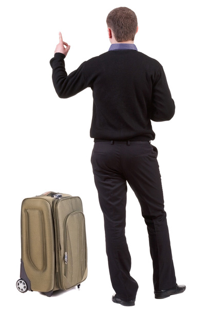 Back view of traveling business man with suitcase pointing. - Fotoğraf, Görsel