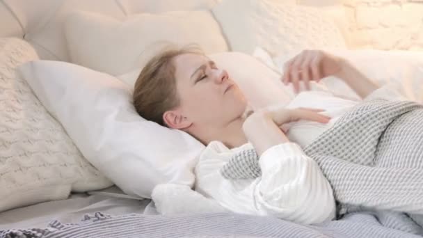 ベッドで眠ろうとする落ち着きのない若い女性 - 映像、動画