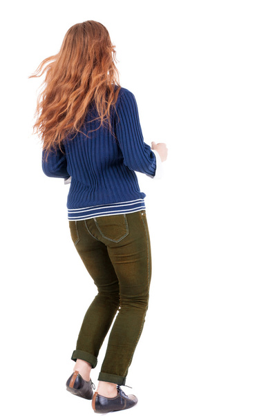 back view of jumping woman in jeans. - Foto, Imagen