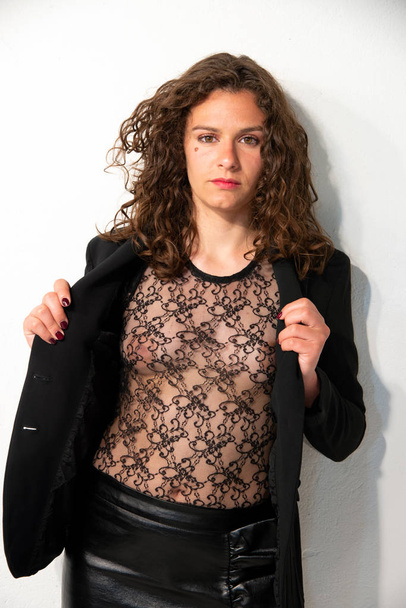 Half-length woman's dress with a transparent black lace sweater and a black jacket. Beautiful brunette girl with curly hair. White background. - Foto, Bild