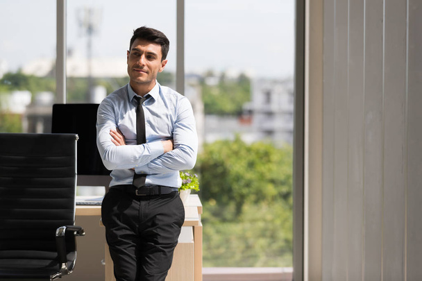Businessman crossed arms and standing in office - Photo, Image