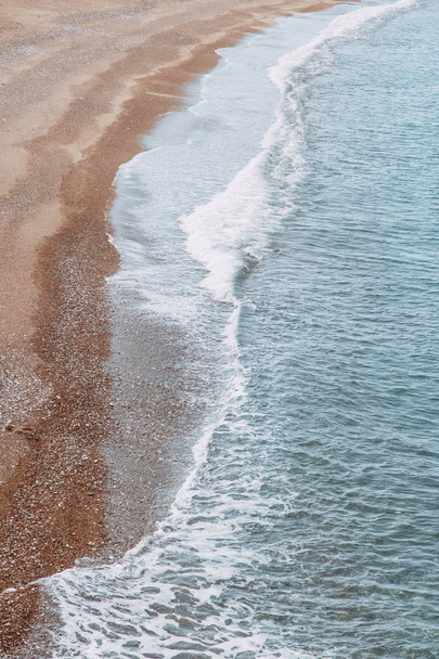 Minimalism of landscapes of Montenegro. Sandy beach and waves view from above.  - Фото, изображение