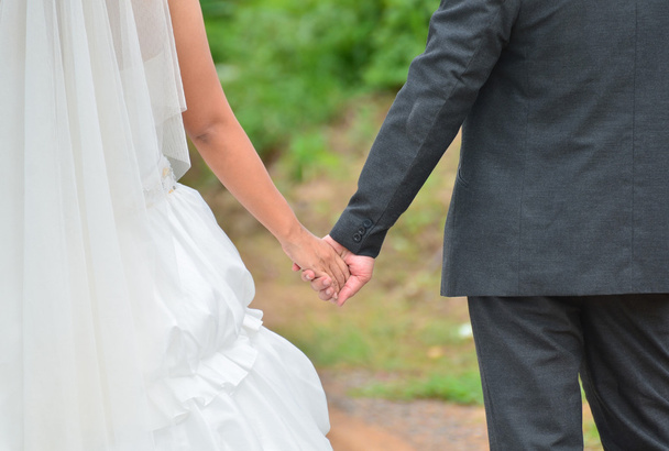 Bride and groom holding hand each other - Photo, Image