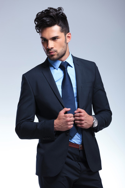business man looks away while holding his lapels - Foto, immagini