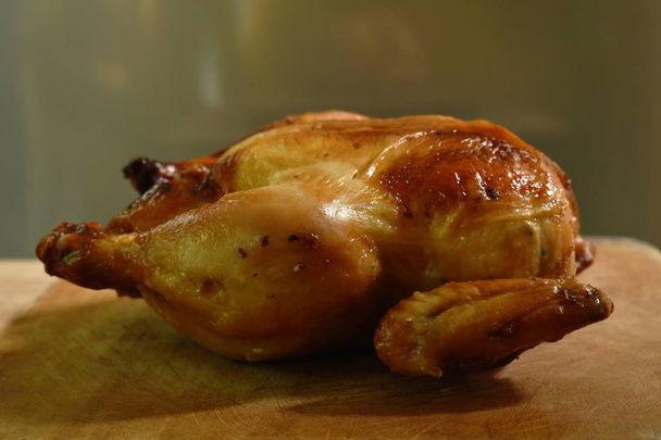  grilled chicken with sweet sauce on wooden chop block in home kitchen - Foto, imagen