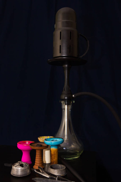 Hookah and four different hookah bowls and kalaud on the table o - Foto, immagini