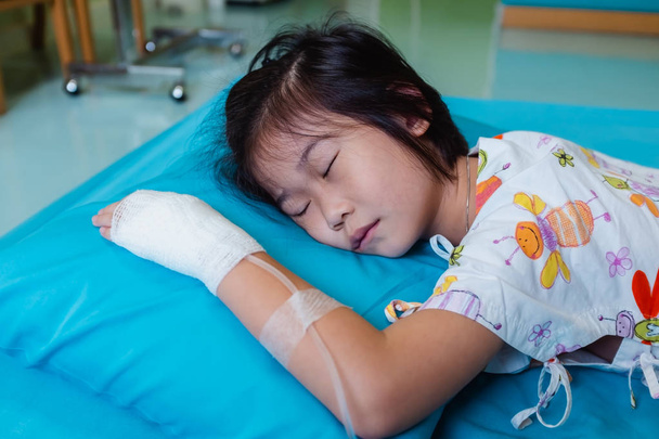 Enfermedad niño asiático ingresado en el hospital con solución salina intravenosa
 - Foto, imagen
