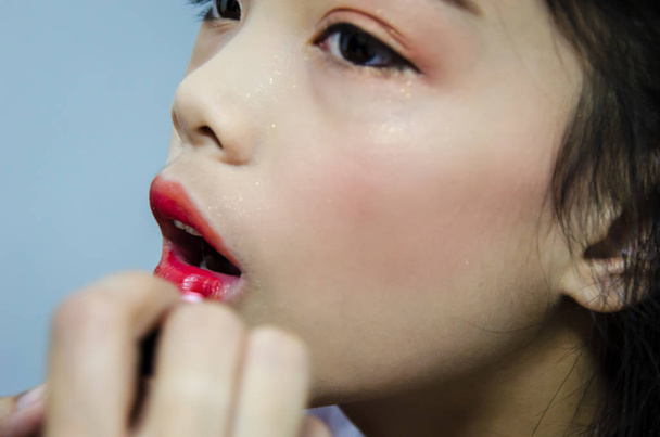 children applying red lipstick - Photo, Image