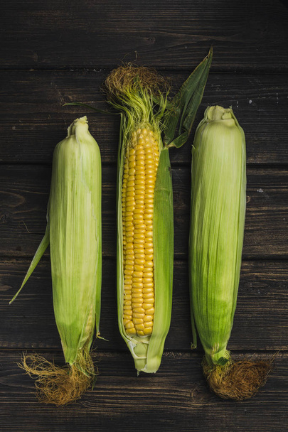 Corn on a dark wood background - 写真・画像