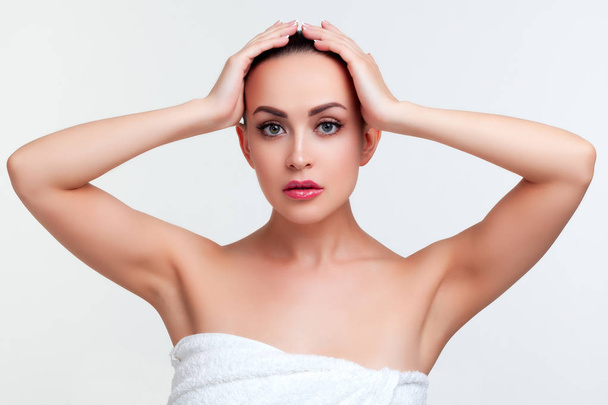 Beauty portrait of young woman in white towel after shower. White background - Photo, Image