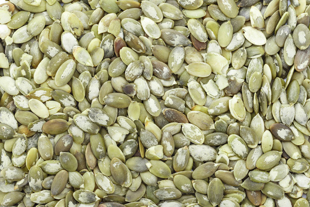 Macro background texture of green pumpkin seeds - Foto, imagen