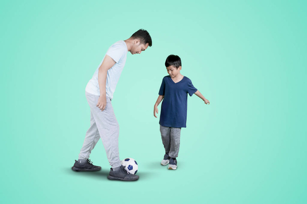 Young man doing soccer exercises with his son - Photo, Image