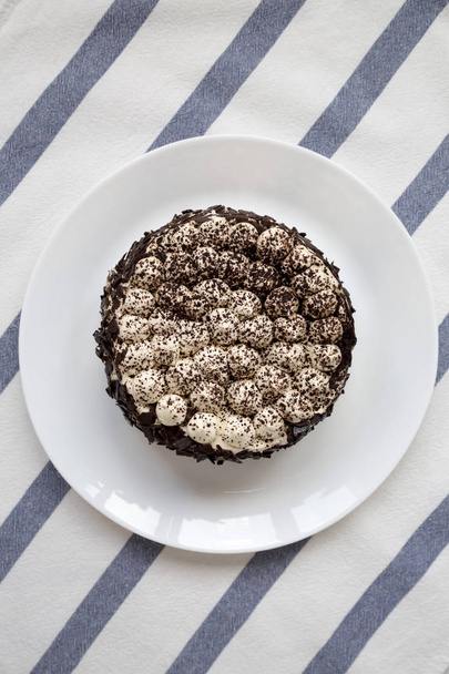 Homemade tiramisu cake on a white plate, top view. Flat lay, ove - Photo, Image