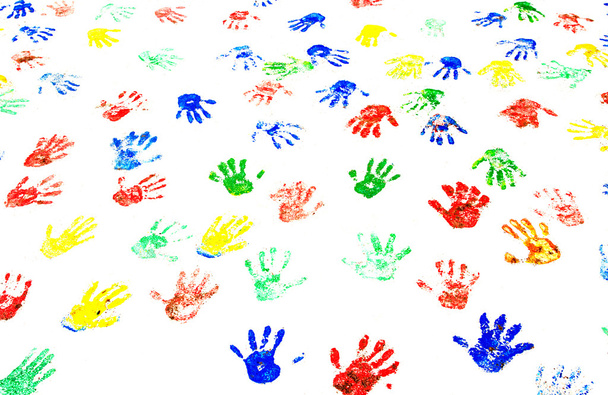 Multicolored handprints on the white wall - Zdjęcie, obraz