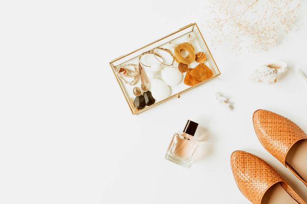Feminine fashion composition with stylish accessories: leather shoes, earrings, perfume, flower bouquet on white background. Flat lay, top view trendy minimal lifestyle concept. - Photo, Image