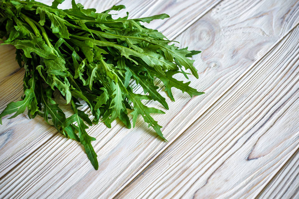 fresh arugula leaves on old wooden table - Photo, Image