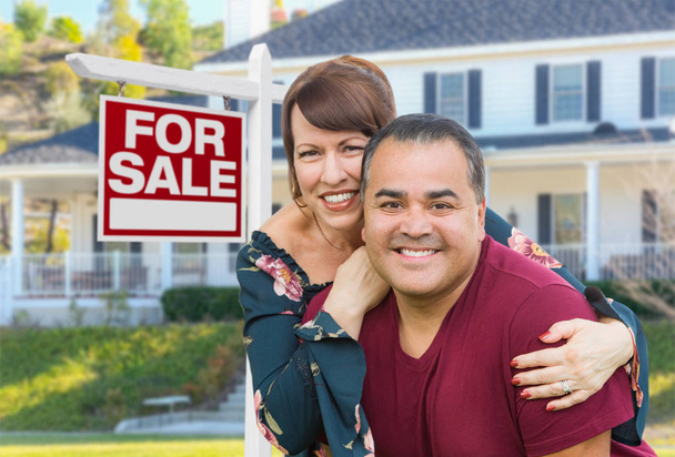 Mixed Race Young Adult Couple In Front of House and For Sale Real Estate Sign. - Foto, Imagem