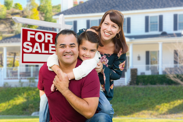 Familia de raza mixta feliz en frente de la casa y en venta
. - Foto, Imagen