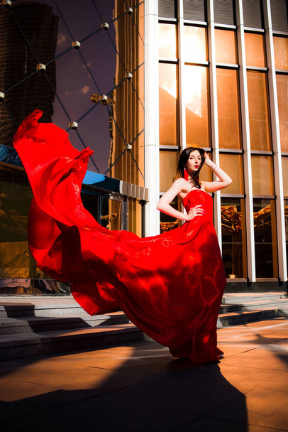 Attractive woman in red fluttered dress. Fire, flame, passion concept. Red Moscow - Foto, immagini
