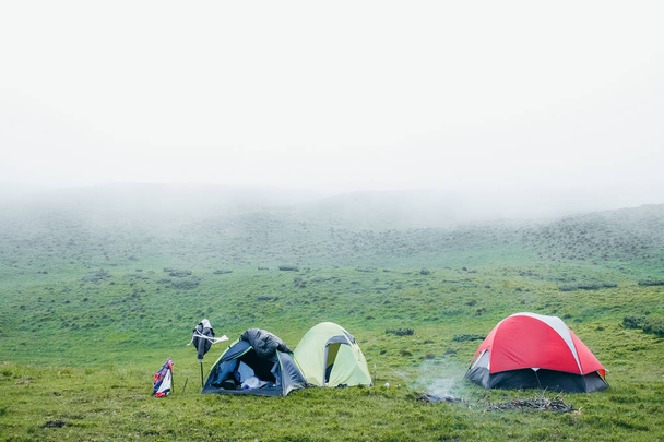 A few camping tents in the mountains on a foggy day - Foto, Imagen