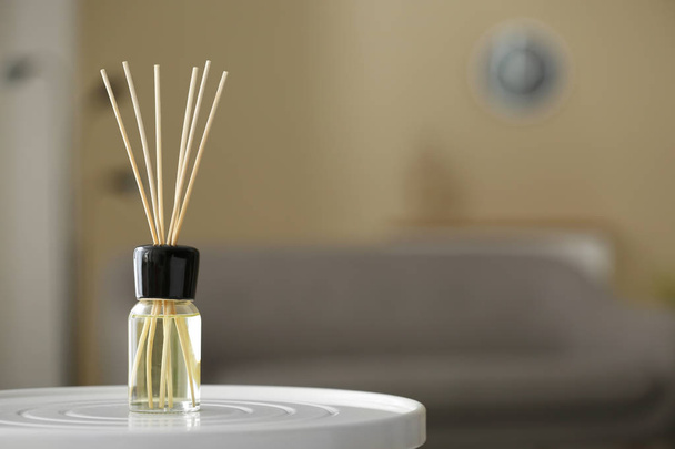 Aromatic reed air freshener on table against blurred background - Foto, Imagem