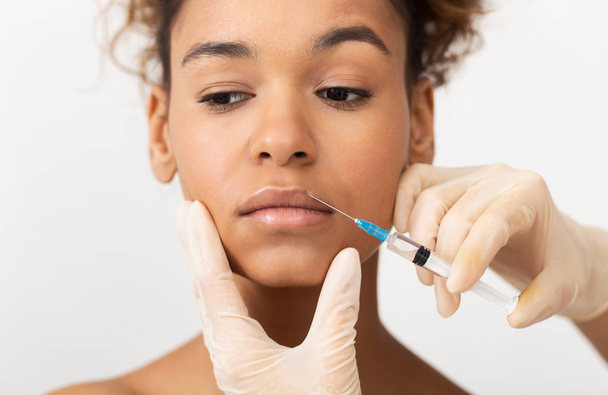 Aesthetic Cosmetology. Beautician Making Injections In Upper Lip - Fotó, kép