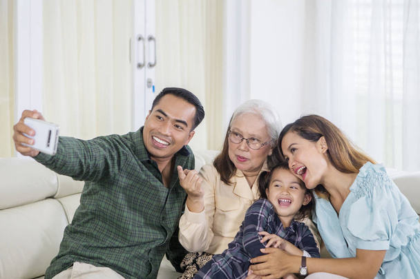 Vidám három generációs család veszi selfie otthon - Fotó, kép