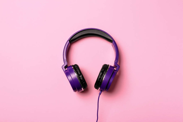 Stylish modern headphones on color background, top view - Fotó, kép