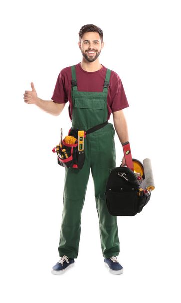 Full length portrait of professional construction worker with tools on white background - Fotó, kép