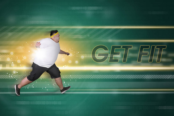 Overweight man chasing text of get fit - Фото, зображення