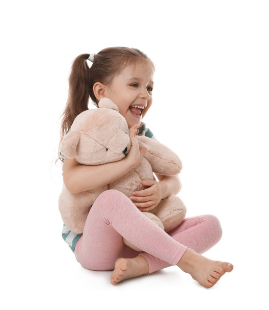 Portrait of cute little girl with teddy bear on white background - Φωτογραφία, εικόνα