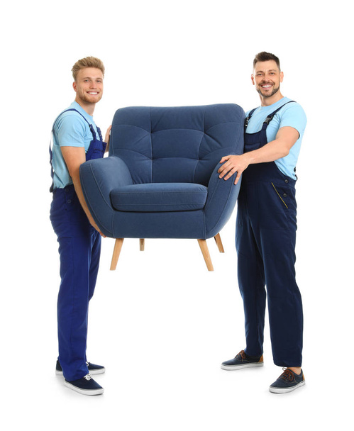 Portrait of moving service employees with armchair on white background - Foto, immagini